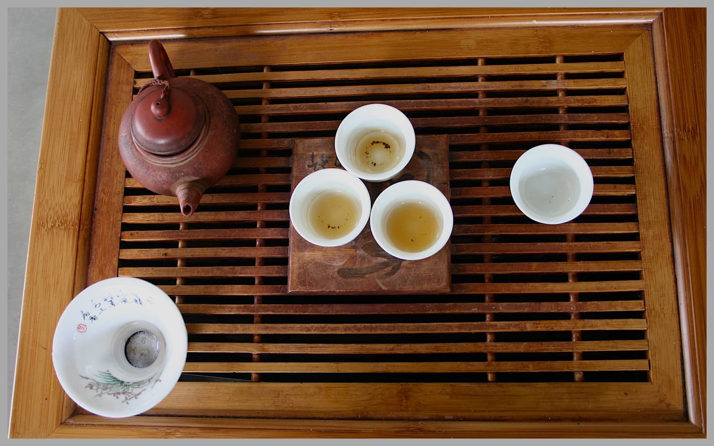 A Teochew-style gongfu tea set: a small brewing pot and tiny cups arranged on a tray for many short infusions.